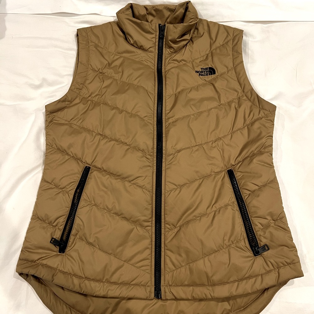 North face women’s tan vest, black zipper, logo on front and back.